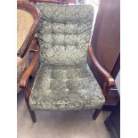 An oak framed armchair with green pattern upholstery