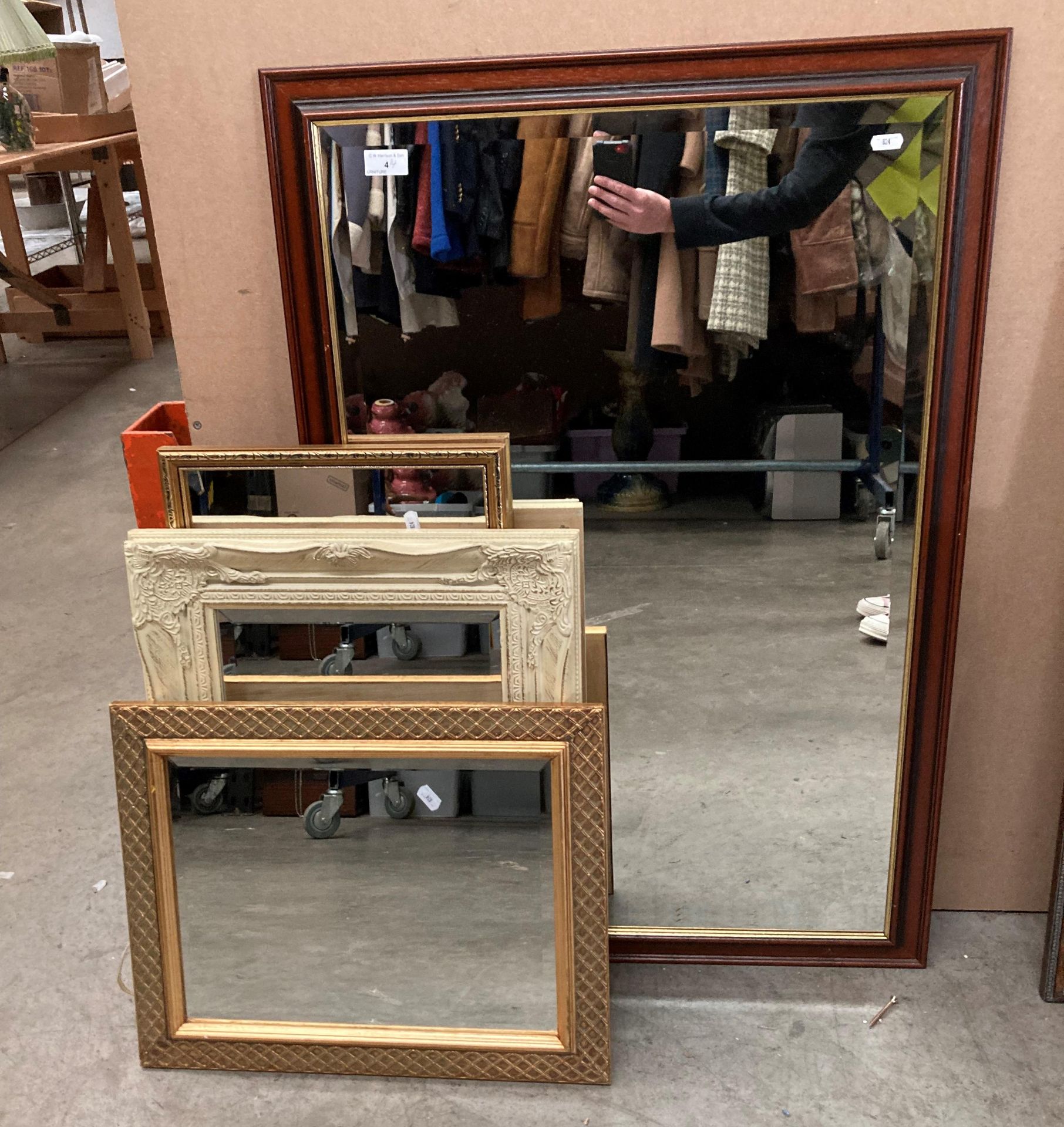 A wood framed wall mirror 97 x 66cm and three other smaller wall mirrors (4)