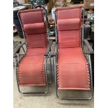 Two patio sun loungers by Lafuma in light red material with grey metal frame