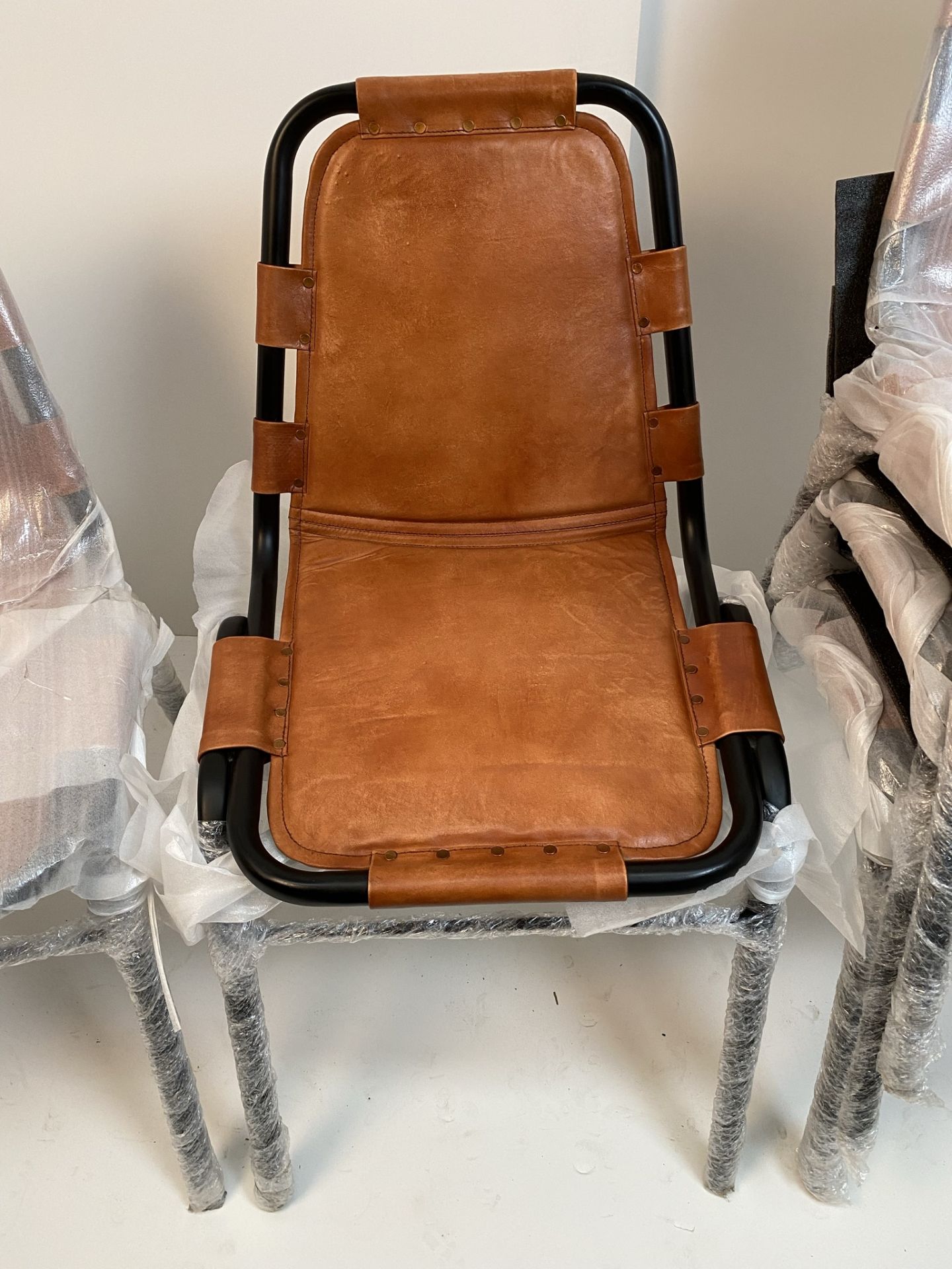 4 x Black Metal Framed Brown Leather Saddle Chairs - (boxed) plus one additional matching chair