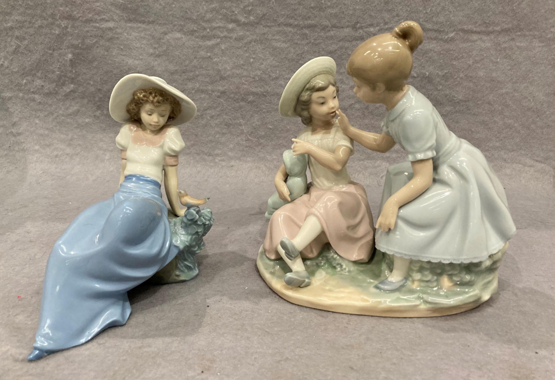 A Nao by Lladro porcelain group of two girls, one with baby,