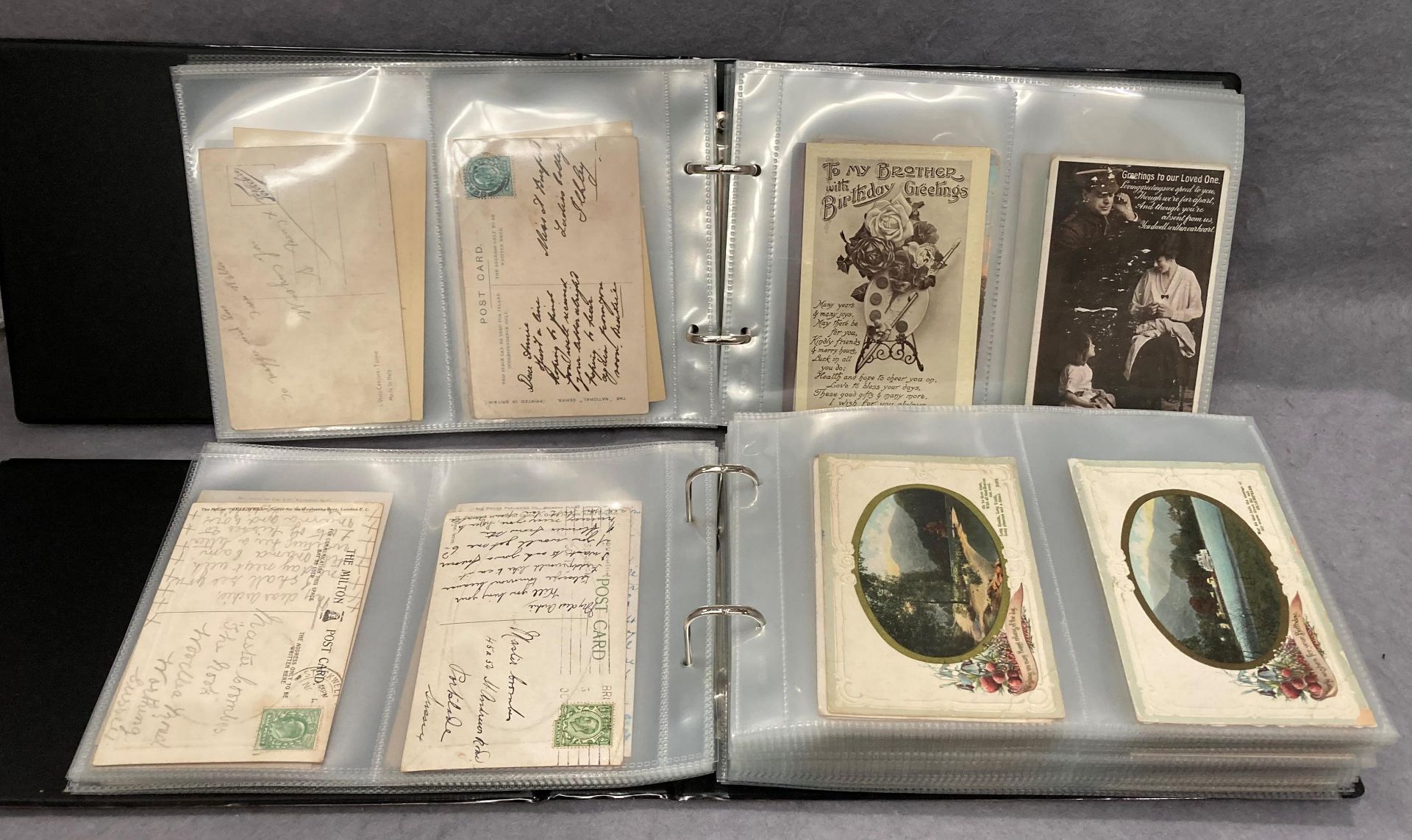 Two postcard albums containing approximately 380 postcards - various genres, places of interest,