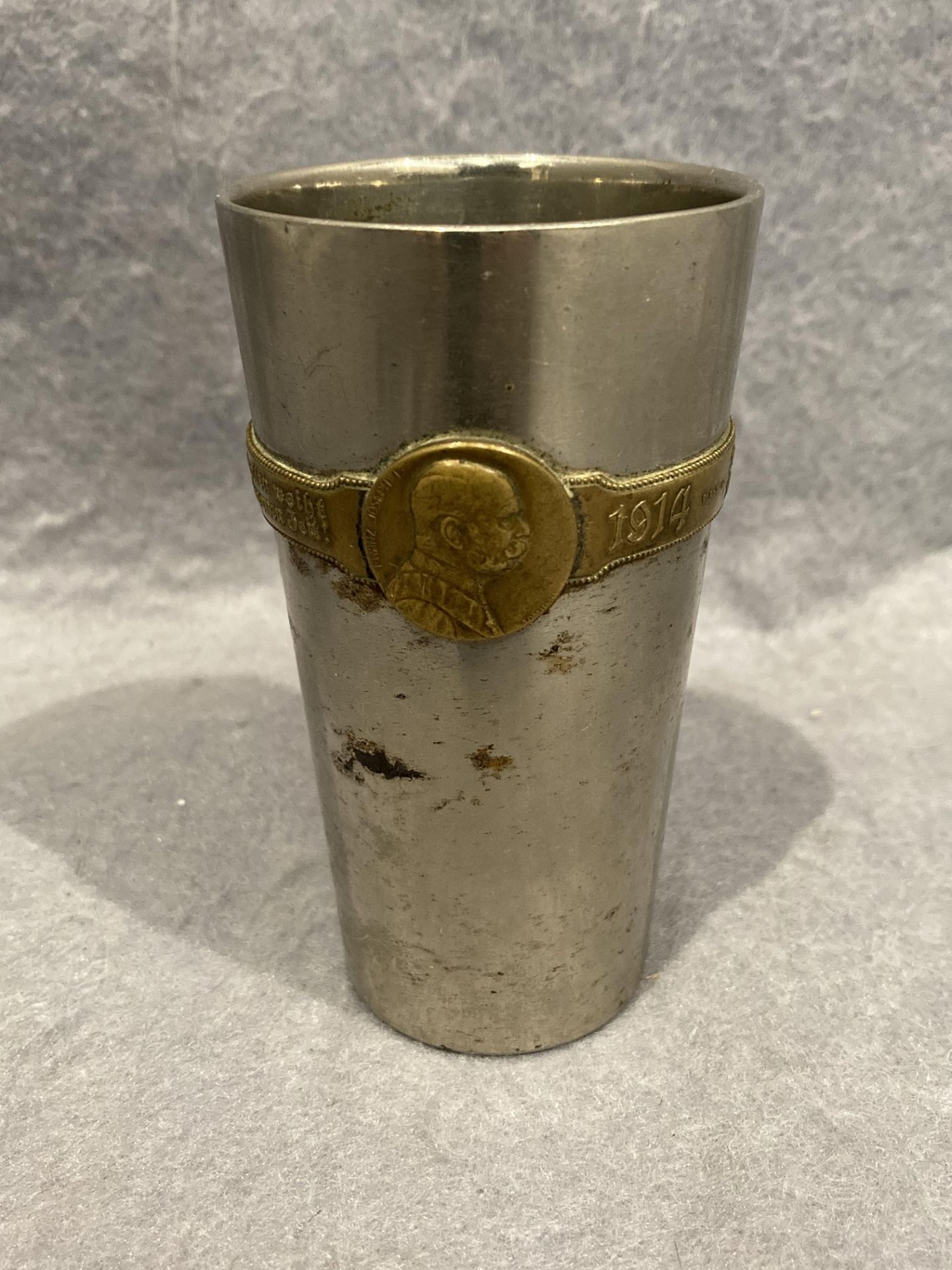 A German metal WWI beaker inscribed 1914-1915 Sriegs Becher with the heads of Wilhelm II and Franz