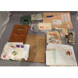 A box containing a quantity of loose used stamps and small stamp albums