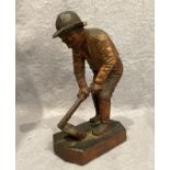 A carved wood model of labourer, 20cm high, with writing to the base M W Westerlund 1824,