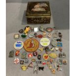 A tin full of various vintage badges, Police cap badges, Butlins (including Clacton 1939),