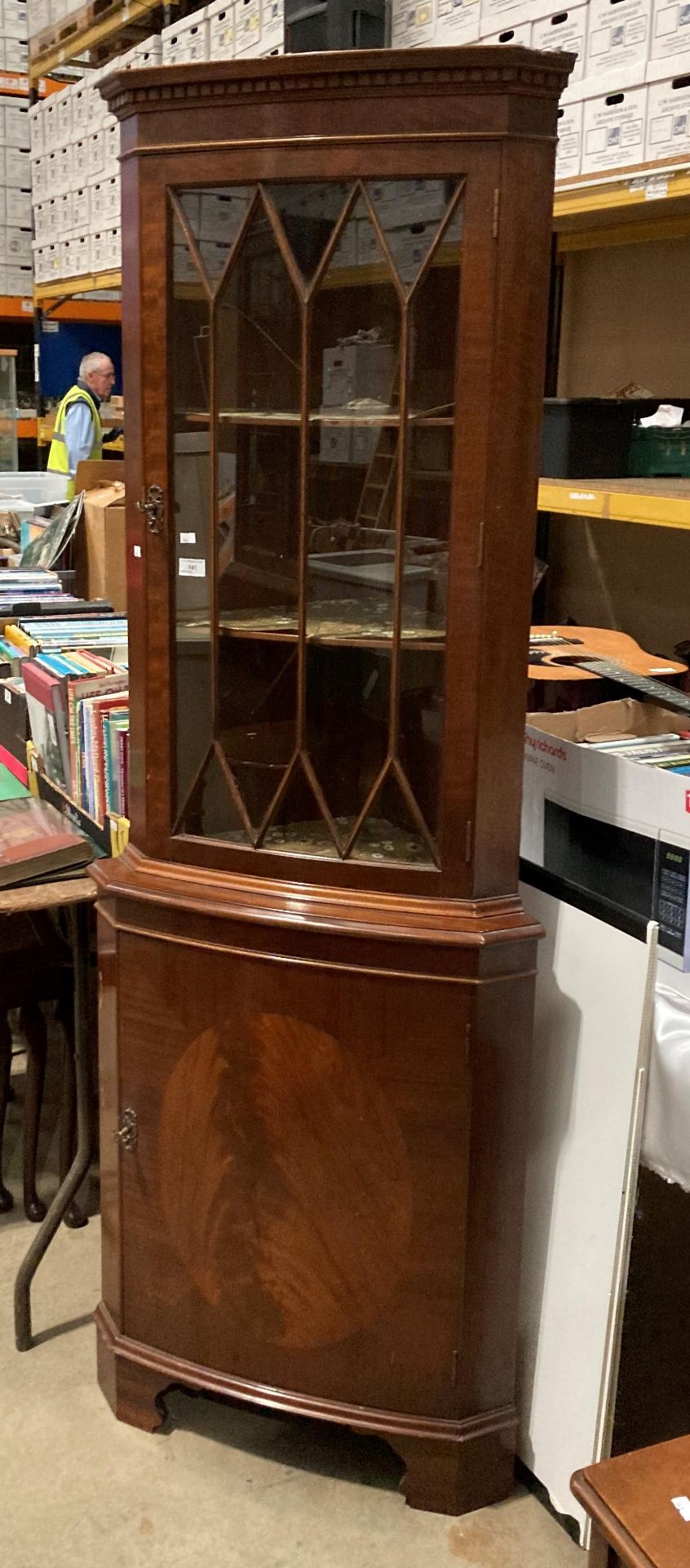 A mahogany reproduction freestanding corner cabinet with glazed door (one section cracked) over