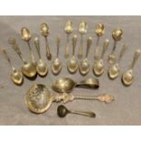 Fifteen assorted silver tea and coffee spoons, an apostle sifting spoon,