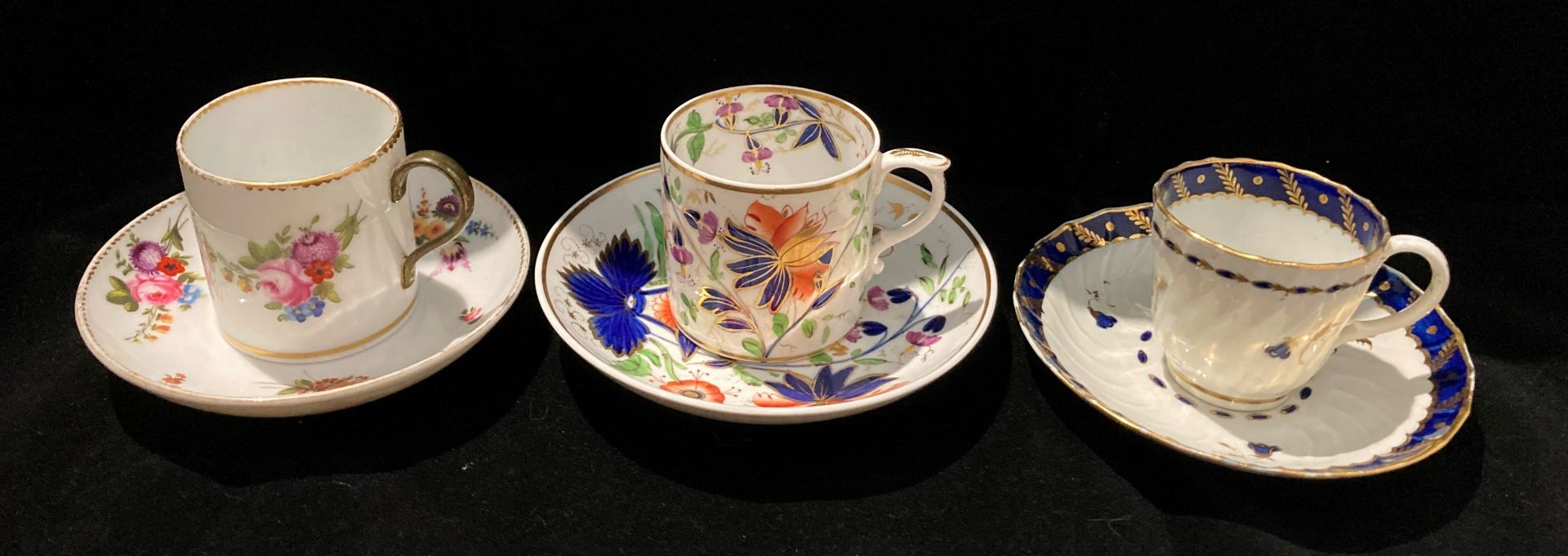 Three patterned cups and saucers