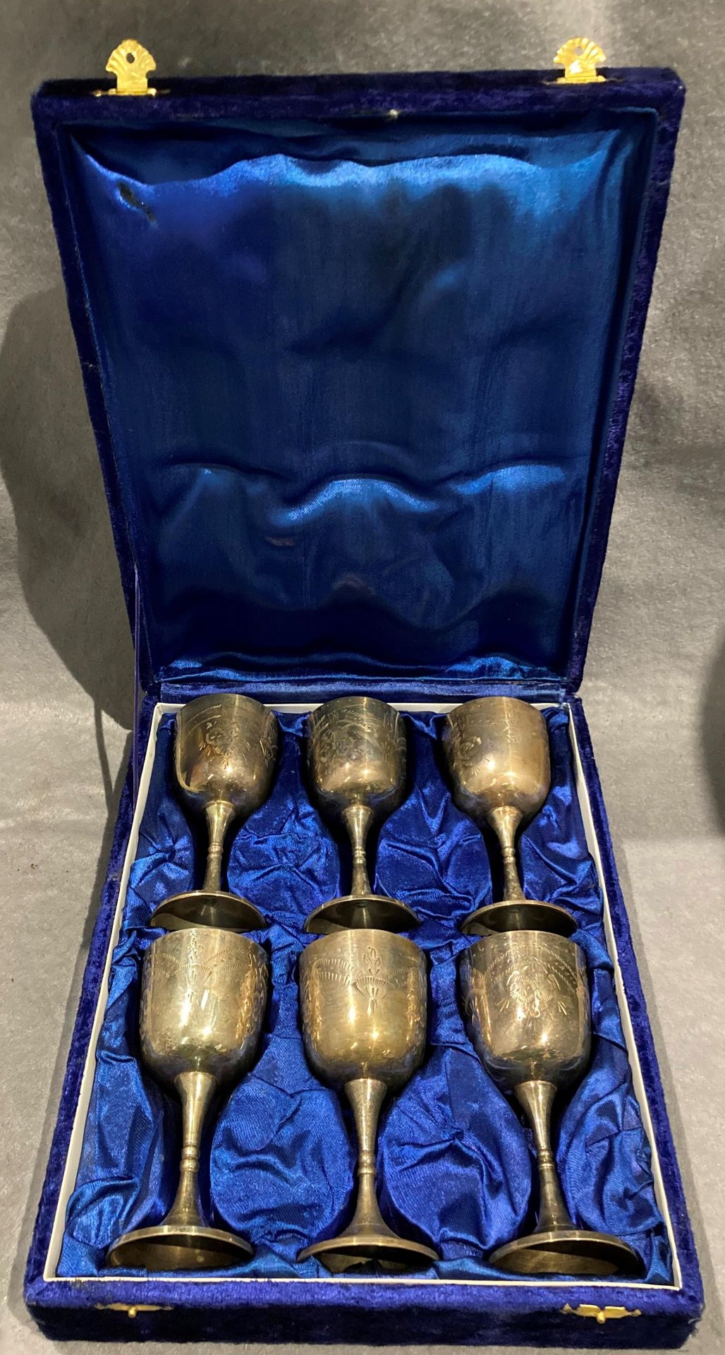 A set of six engraved plated goblets in blue velvet finish case