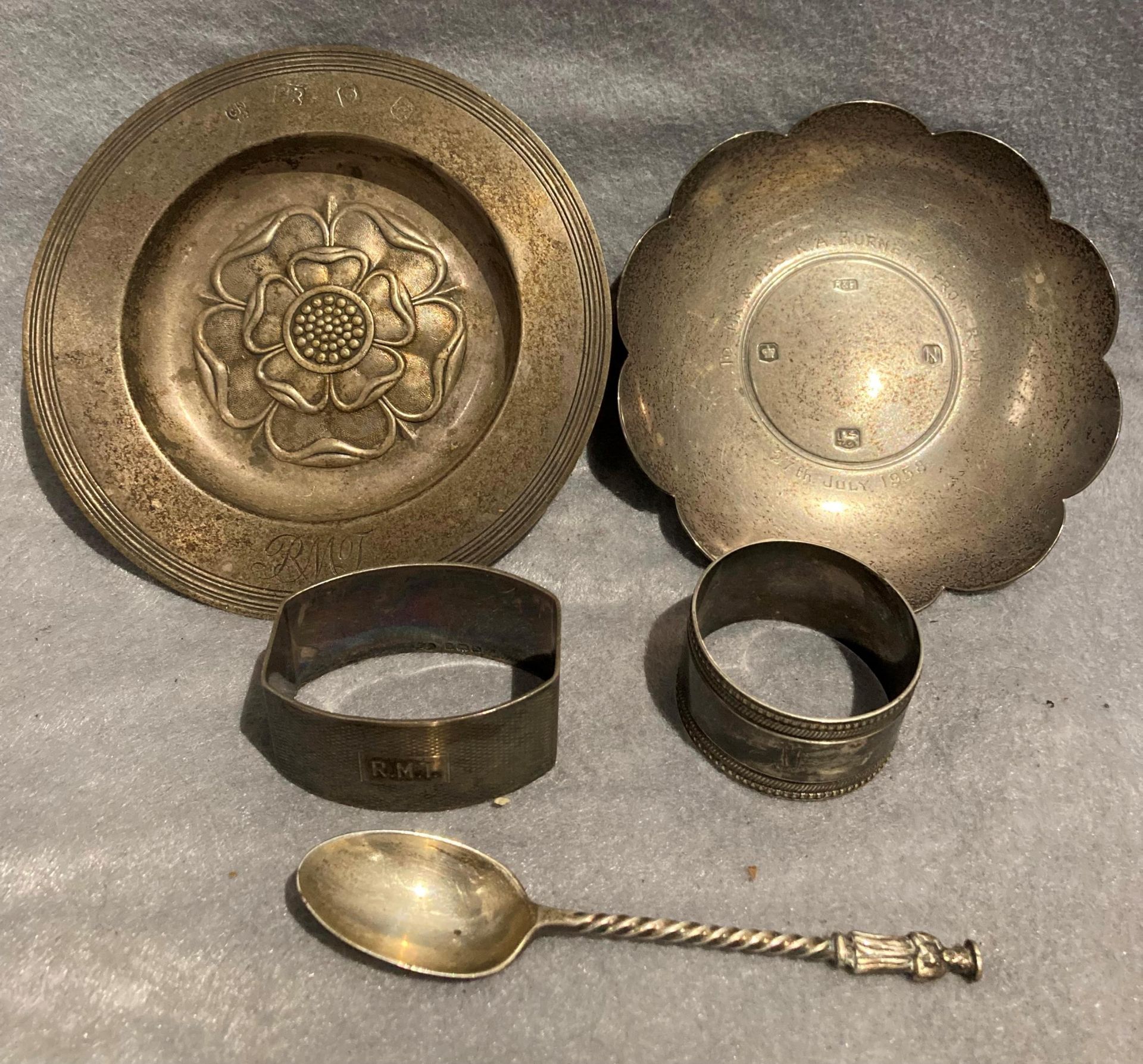 Two small silver dishes, a silver napkin ring, a silver spoon, total approximate weight 7.