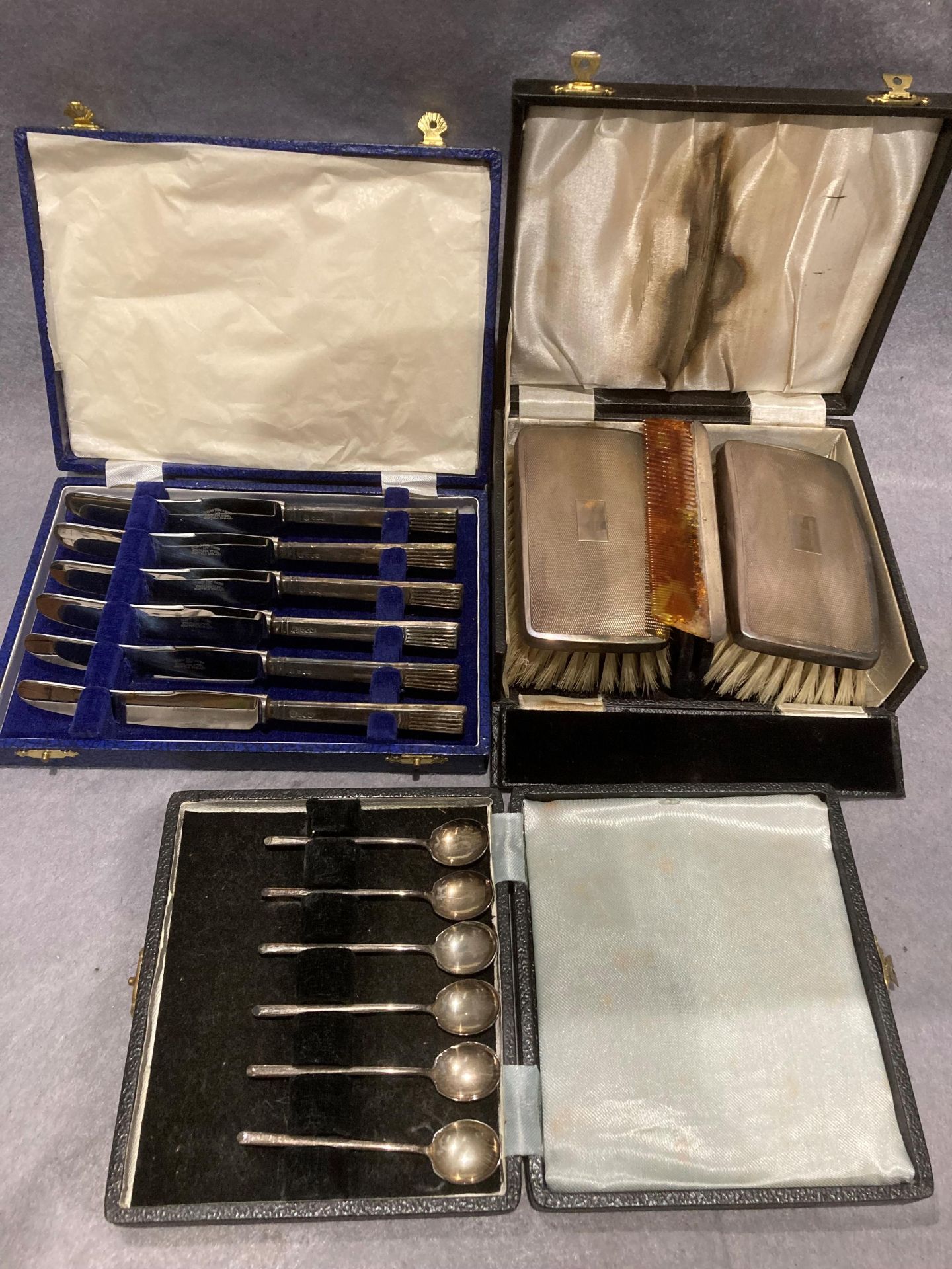 A cased silver back two piece clothes brush set,