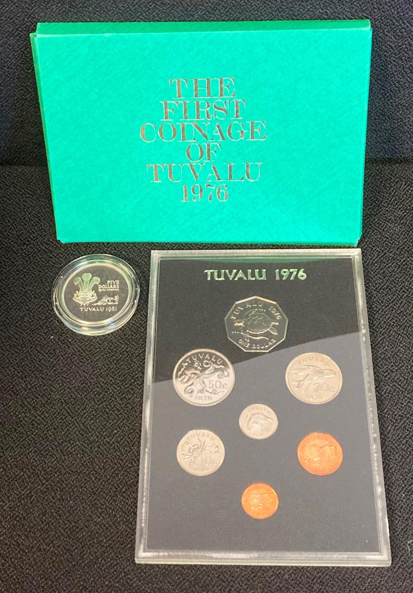 A Tuvalu 1981 Five Dollars Silver coin together with a Royal Mint the First Coinage of Tuvalu 1976