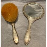 A silver backed hand mirror and hair brush (2)
