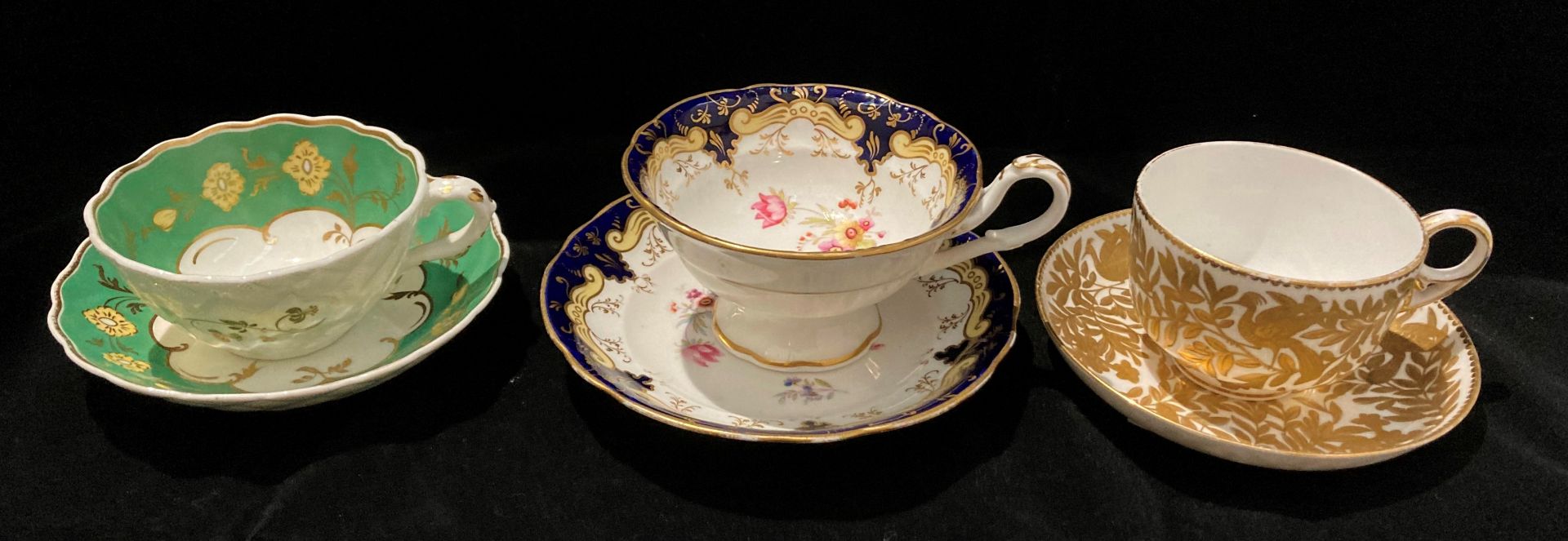 Three patterned cups and saucers