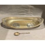 An oval silver dish with pierced rim 33cm and a silver teaspoon, total approximate weight 10.
