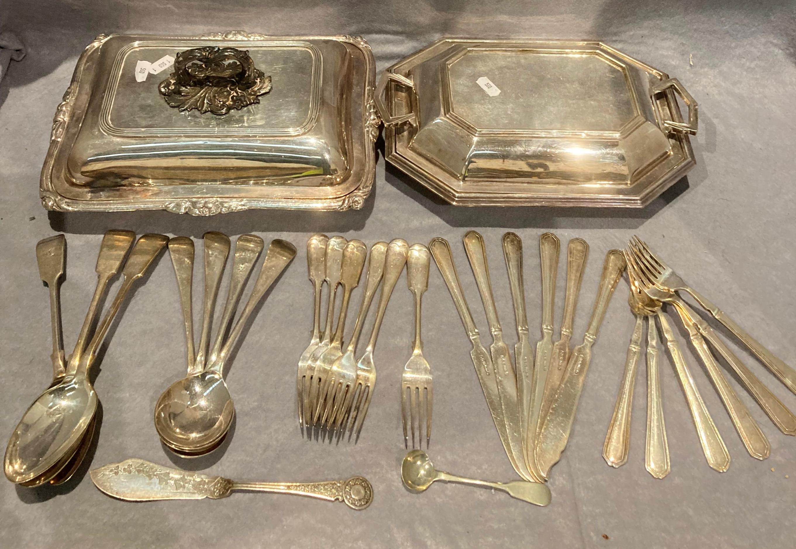 Two silver plated entree dishes and a quantity of plated cutlery in a green roll