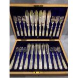 A twenty-four piece set of fish knives and forks with mother-of-pearl handles,