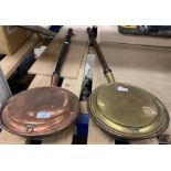 A copper and a brass long handled bed warmers