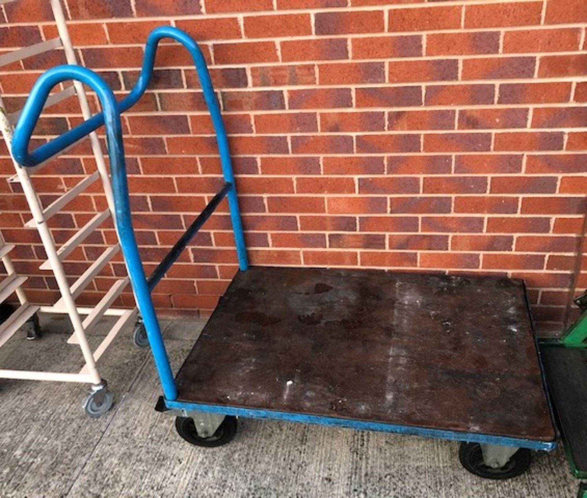 Blue metal industrial four wheel trolley,