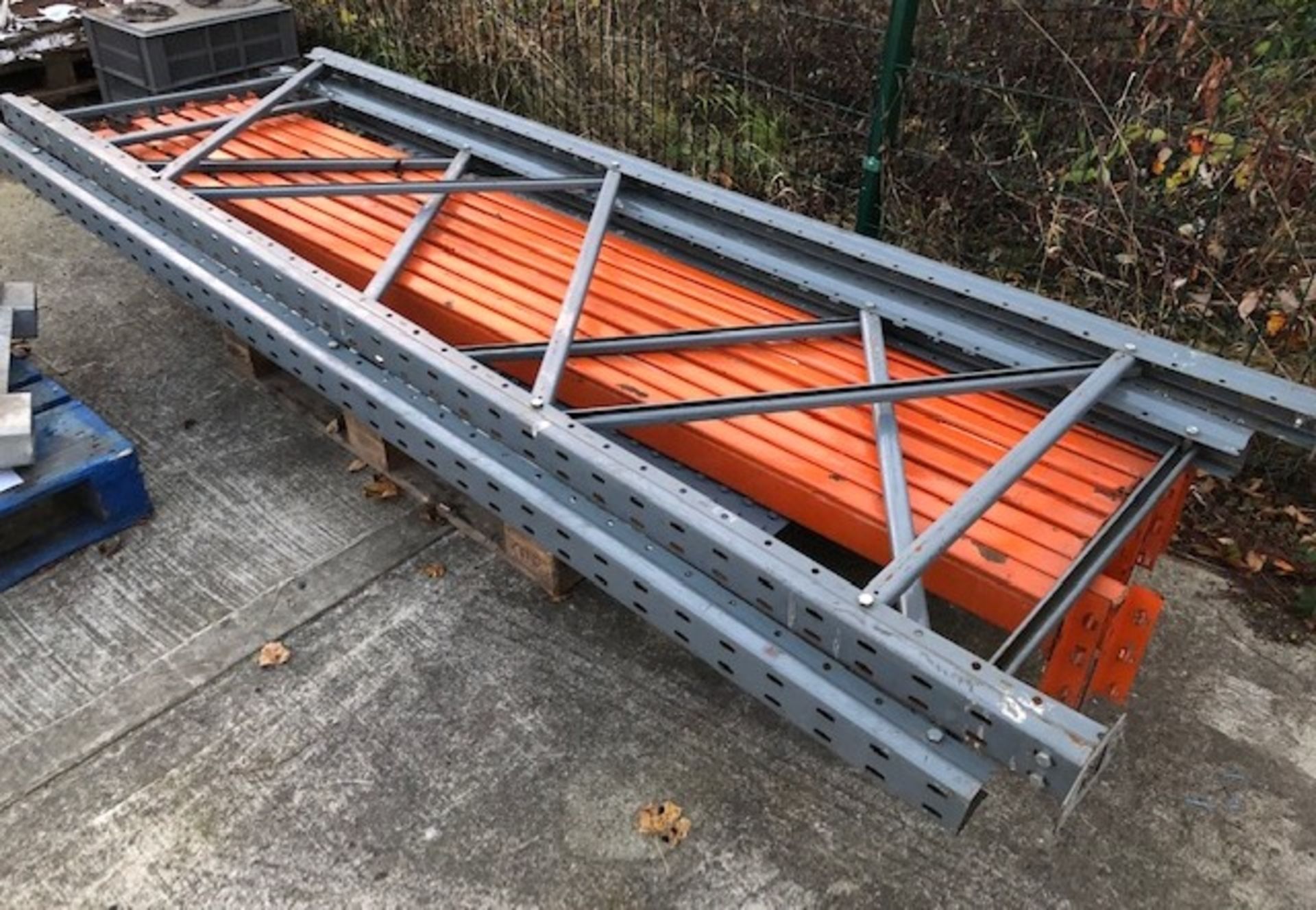 Two grey metal pallet rack uprights, each 90cm x 282cm high and eight orange brackets,