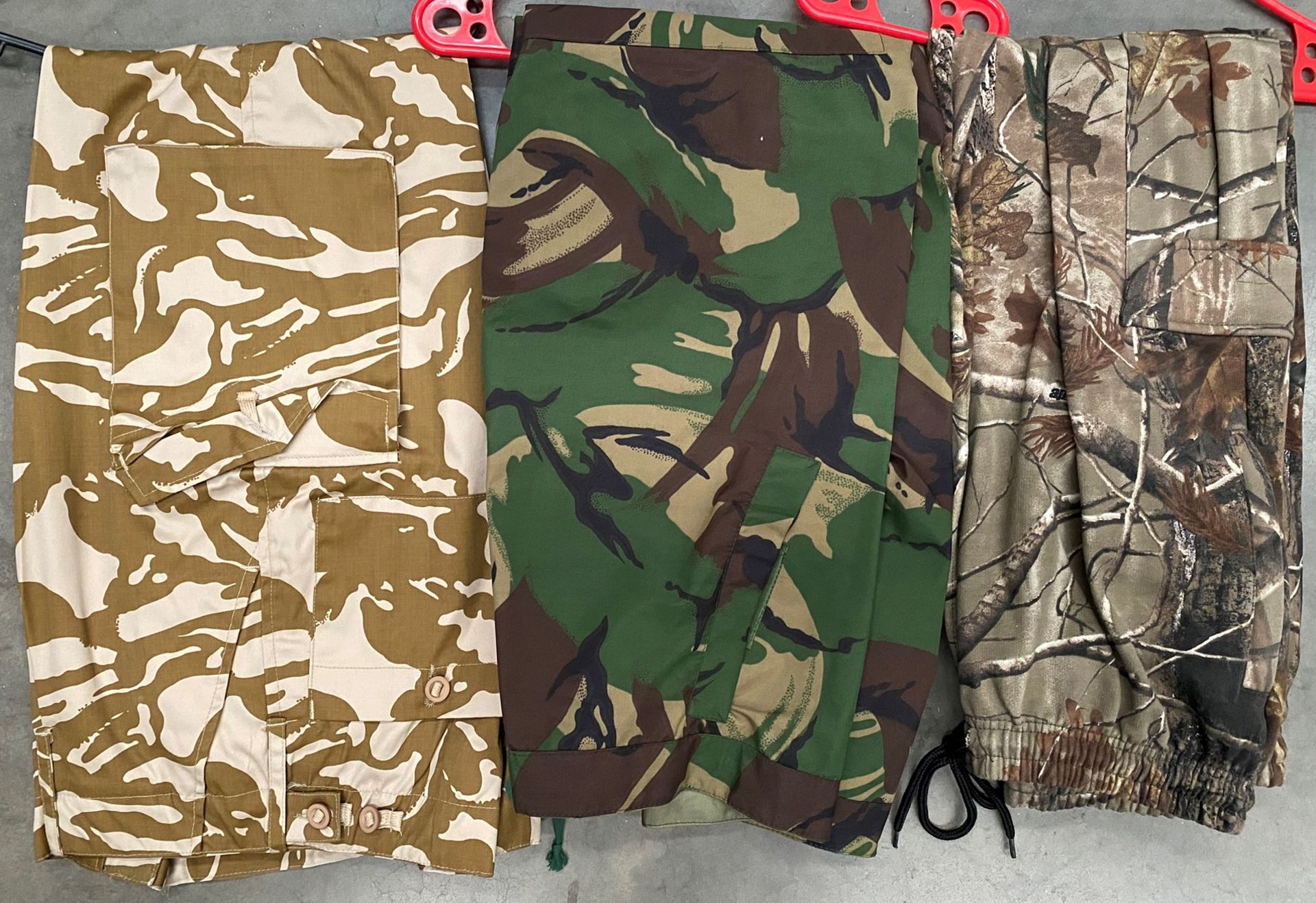 Three pairs of camouflage trousers by Countrywear, GGS Military Workwear, Bernard uniforms,