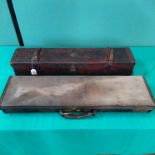 A canvas and leather gun case for max 30" barrels with a vintage leather example including a