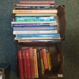 A box of firearm reference books including 'Guns of the American West' together with a wallet