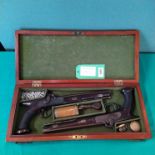 A cased pair of saw handle percussion target/duelling pistols by Holden Liverpool,