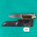 A vintage folding Bowie hunting knife, 12 1/2" overall with a 8 1/2" spear point blade,