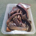 A box of various leather holsters, bandoliers etc including Sam Browne with holster and whistle,