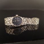 A lady's 18ct white gold Omega watch with 18ct gold strap, approx 39.