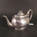 A Georgian silver teapot with engraved decoration,