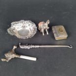 A pierced silver bon bon dish (as found), a silver and mother of pearl baby rattle,