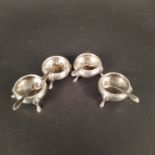 A set of four Victorian silver cauldron shaped salts with bead design edge on three legs,