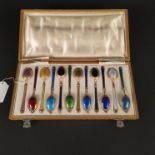 A set of twelve multi-coloured enamelled silver demitasse spoons, 84 marked,