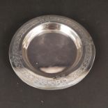 A silver dish with engraved ribbon and leaf border, Chester 1908, makers mark worn,