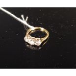 An 18ct gold three stone diamond ring, centre stone approx 0.5cts, size K, approx 3.