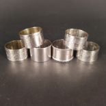 Mixed silver napkin rings including Victorian foliate engraved examples (four with engraved