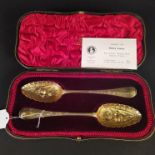 A boxed pair of silver gilt berry spoons, different makers and dates, 1760 and 1762,