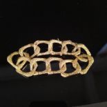 A modernist heavy 18ct gold rectangular link bracelet with bark effect