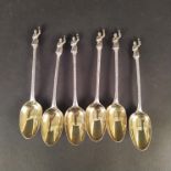 Six silver spoons with figural finials, engraved stems and gilded bowls (marks heavily worn),