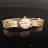 A lady's 18ct gold Omega watch on 9ct gold bark effect strap