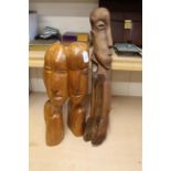 A wooden Easter Island style conjoined head figure,
