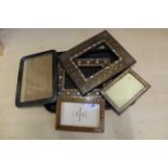 A selection of antique picture frames including two well worked inlaid examples set with metal and