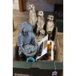 A group of three plus one other of meerkats, a ceramic seated child figure,