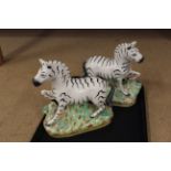 A pair of Staffordshire zebra figurines,