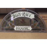 A stained glass fan light for Sun-Ray House with central bird panel