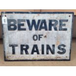 A vintage cast metal warning sign 'Beware of Trains',