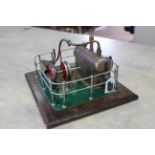A vintage hand built model steam engine with chrome railings